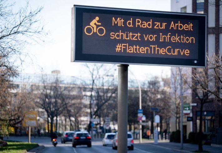 23 March 2020, Berlin: “Cycling to work protects[-] against infection #FlattenTheCurve” Photo: Kay Nietfeld/dpa (Photo by Kay Nietfeld/picture alliance via Getty Images) DPA/PICTURE ALLIANCE VIA GETTY IMAGES