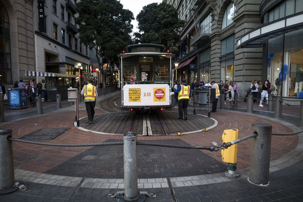 San Francisco Municipal Transit Agency employees turn an empty cable car in San Francisco on March 4. The city has taken advantage of the commuting and tourism lull to complete transportation-related construction projects. David Paul Morris/Bloomberg 